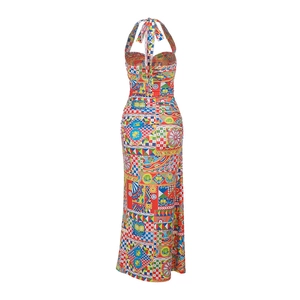 Detail of multi-color printed halter maxi dress showing backless design and vibrant patterns