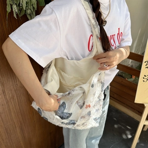 Detailed interior view of white butterfly tote bag with fuzzy texture and zipper pocket