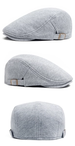 Detail view of grey knitted cotton ivy cap showing metal side adjustment buckles