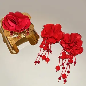 Metallic gold cuff and long tassel earring set with 3D red fabric flower accents