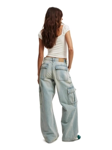 Women's light blue washed cargo jeans in wide leg fit with large pockets, back view
