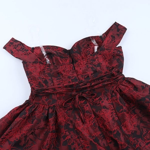 Detail of off-the-shoulder neckline and waist ties on wine red lace mini dress