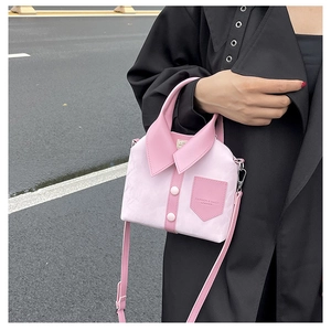 Detail of pink shirt-shaped tote bag featuring decorative buttons and a stylish collar