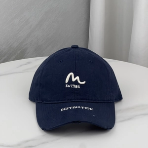 Detailed view of the embroidered navy blue cotton baseball cap with distressed brim finish