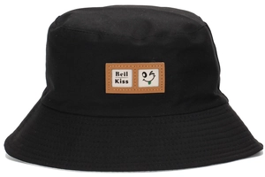 Close-up of black cotton bucket hat featuring a leather patch with wink face and text
