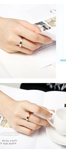 Detailed view of 4mm silver and rose gold polished stainless steel rings on a magazine