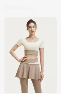 Detail of high-stretch yoga set featuring beige contrast top and brown skirt-legging combo
