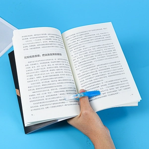 Close-up of a blue transparent resin book page holder ring for hands-free reading