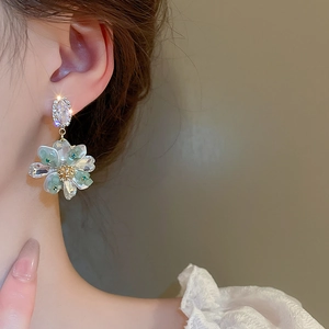 Close-up of elegant floral dangle earring with crystals on a model for a chic style