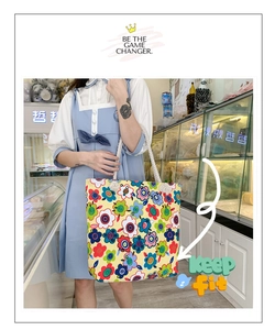 Close-up of vibrant pop art floral canvas tote with white braided rope handles