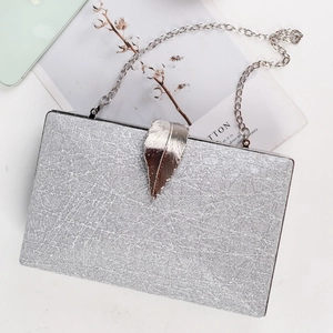 Silver textured rectangular evening clutch bag with leaf metal clasp and chain strap