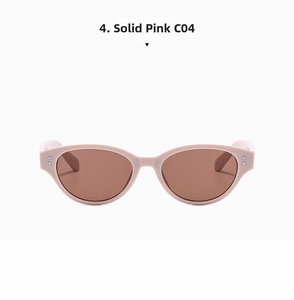 Detail view of pink cat-eye sunglasses with reddish-brown lenses and metal dot accents