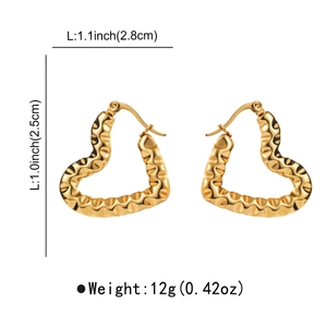 Detail of gold heart twist earrings showing wave texture and size measurement
