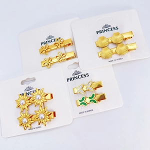8-piece gold stainless steel starfish and butterfly hair clip set on a display card