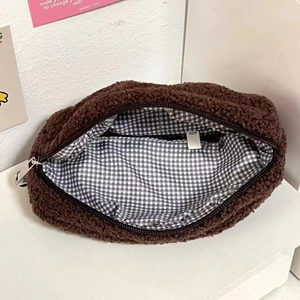 Detail of plush brown sherpa pencil case showing checkered lining and secure zipper