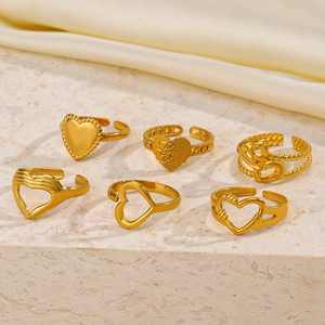 Detail of 18K gold-plated stainless steel heart ring with Love You engraving on stone surface