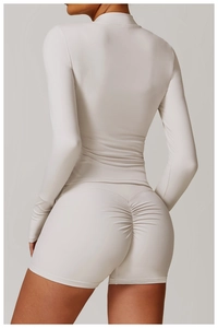 Detail of high-stretch beige yoga set with flattering ruched seam on back shorts