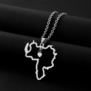 Detail of silver Venezuela map pendant necklace with small heart charm on black background