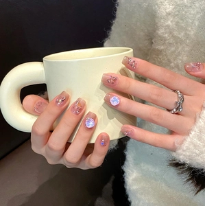 Handmade blush cat-eye press-on nails with 3D rhinestones and laser glitter accents