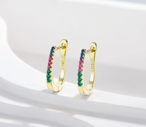 Detail of U-shape 925 silver gold earrings with blue pink and green gradient zircons