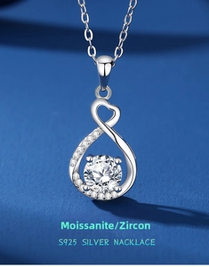 Macro shot of S925 sterling silver heart and infinity pendant with moissanite stones