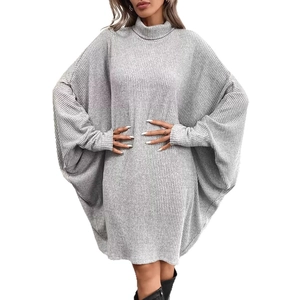 Close-up of grey oversized turtleneck dress featuring ribbed texture and batwing sleeves