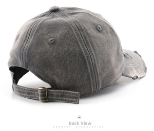 Detail view of washed cotton baseball cap showing back metal buckle and distressed texture