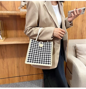 Classic houndstooth canvas tote bag with a wooden button detail shown on a model