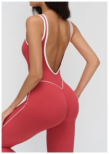 Detail of brick red yoga bodysuit featuring stylish open back and white contrast binding