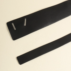 Close-up of black PU leather belt details showing smooth texture and strap holes
