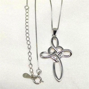 Close-up of S925 sterling silver Celtic knot cross pendant with detailed link chain