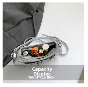 Detail shot of silver leather motorcycle shoulder bag showing interior capacity for lipsticks