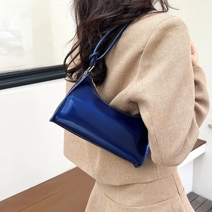 Minimalist navy blue patent leather baguette bag with knotted strap detail for women