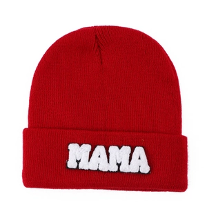 Red knit beanie featuring white MAMA towel embroidery on a clean white background