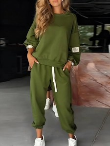Detail of knitted olive green tracksuit with long-sleeved top and drawstring pants