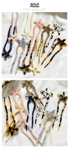 Detailed tile display of various acetate starfish U-shaped hair pins with diverse textures