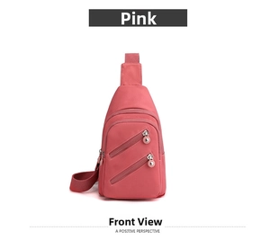 Close-up of pink nylon crossbody bag featuring double diagonal zipper pockets and woven strap