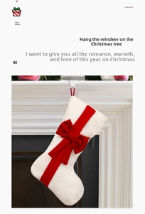 Detail of plush cream Christmas stocking with red velvet bow hanging on a white fireplace