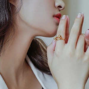 Minimalist double ball open ring in 18K gold plated titanium steel worn on finger