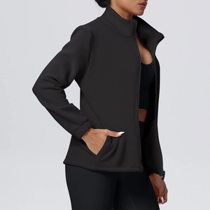 Close-up of black fleece sports jacket with stand collar and zipper detail on woman
