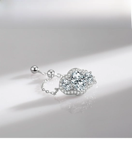 Macro shot of S925 silver ring featuring three halo-set zircons and adjustable chain band