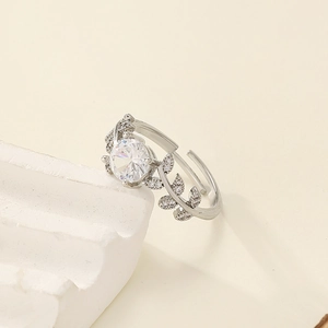Macro shot of laurel leaf moissanite ring with shimmering round-cut center stone