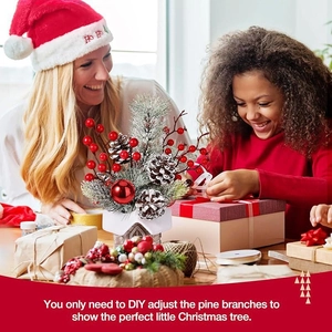 Miniature desktop Christmas tree with red berries and pine cones in a warm family gift scene