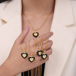 Elegant gold-plated heart necklace with black enamel inlay and sparkling diamond accents