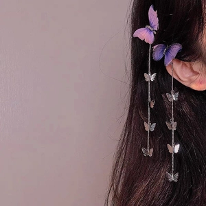 Detail of butterfly hair clip with purple gradient wings and silver tassel chains on hair