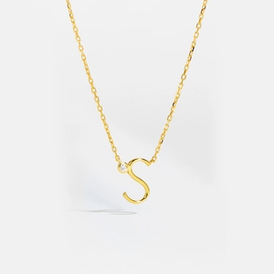 Macro shot of gold S925 sterling silver letter S pendant necklace with small diamond