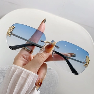 Chic rimless sunglasses with blue gradient lenses and gold butterfly accents for women