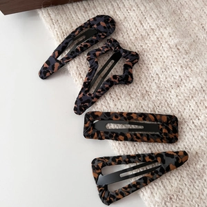 Set of four vintage leopard print fabric hair clips in assorted geometric shapes