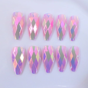 Detail of long almond press-on nails featuring aurora iridescent diamond-cut facets