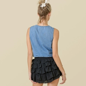 Fashionable denim vest paired with layered black ruffled skirt, back view for women